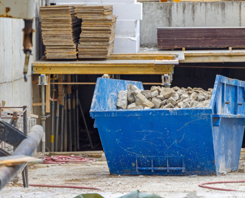 Front view of a container full of construction debris at a construction site