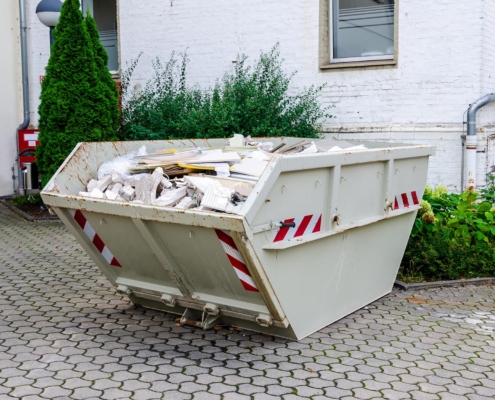 Skip bin on commercial property full of debris