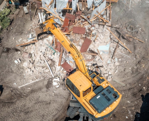 Process of demolition of old building dismantling aerial view